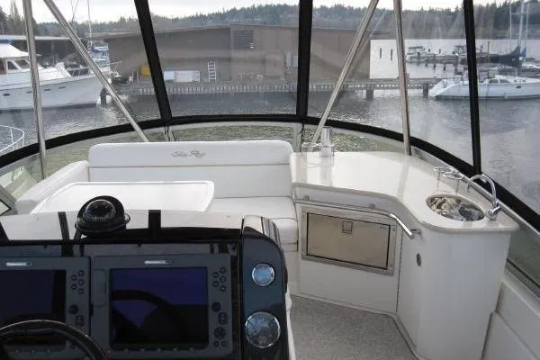  Yacht Photos Pics 2008 Sea Ray 47 Sedan Bridge helm with navigation controls and marina view.