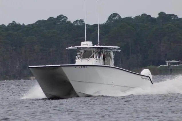 No Worries Yacht Photos Pics 2022 Freeman 34 boat cruising on water with forested background.