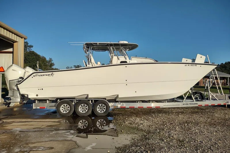 No Worries Yacht Photos Pics 2022 Freeman 34 boat on trailer, parked outdoors under clear blue sky.