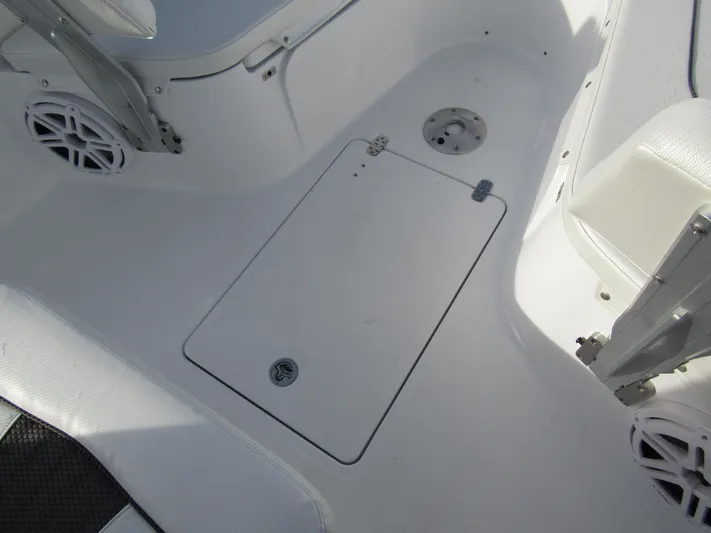  Yacht Photos Pics 2025 Wellcraft 243 Fisherman boat interior, featuring a clean, white deck with storage hatch.