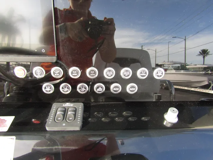  Yacht Photos Pics Control panel of 2025 Wellcraft 243 Fisherman boat with various buttons and switches.