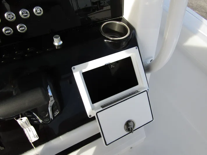  Yacht Photos Pics Wellcraft 243 Fisherman 2025 console with cup holder and storage compartment.