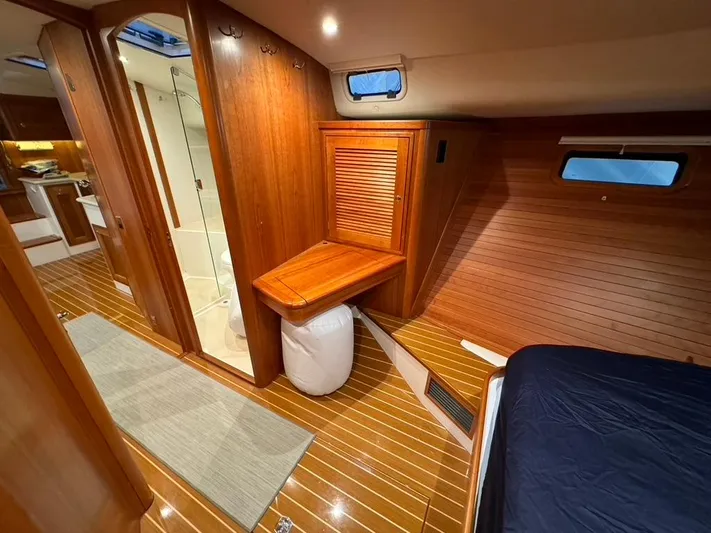 Scarlet Yacht Photos Pics Luxurious 2019 MJM 50z yacht interior with wooden finish, featuring a cozy cabin and modern amenities.
