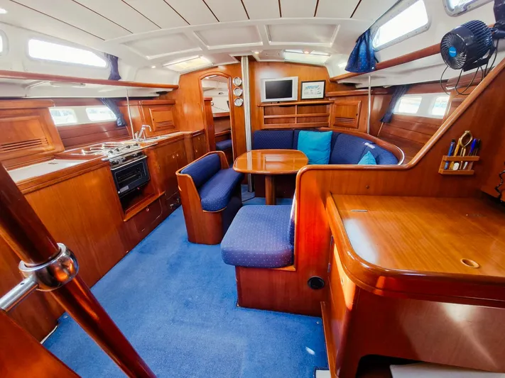  Yacht Photos Pics Interior of 2004 Beneteau Oceanis 423 yacht with wood finish and blue upholstery.