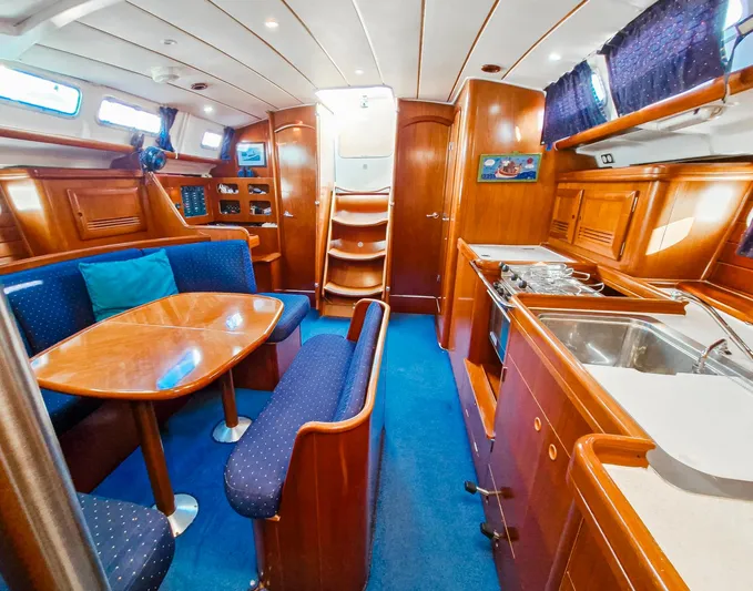  Yacht Photos Pics Luxurious interior of 2004 Beneteau Oceanis 423 yacht with dining area and kitchen.