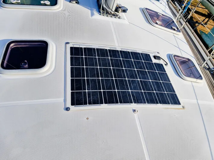  Yacht Photos Pics Solar panel on 2004 Beneteau Oceanis 423 yacht deck, surrounded by hatches.