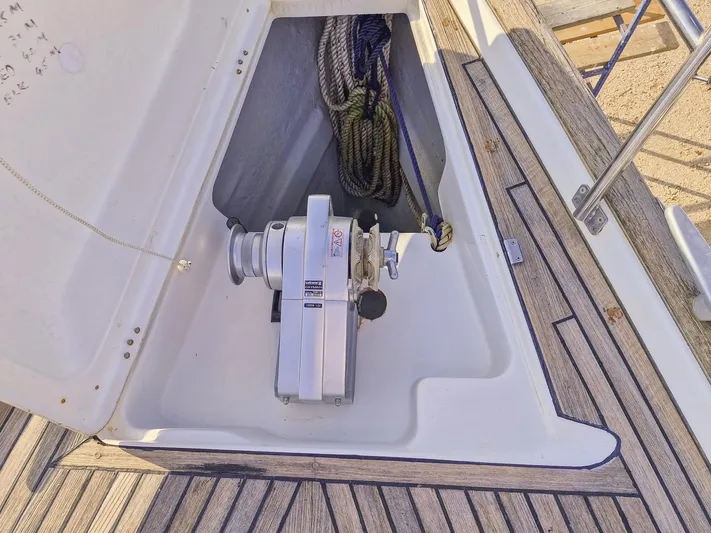  Yacht Photos Pics Beneteau Oceanis 423 (2004) anchor locker with winch and ropes on teak deck.