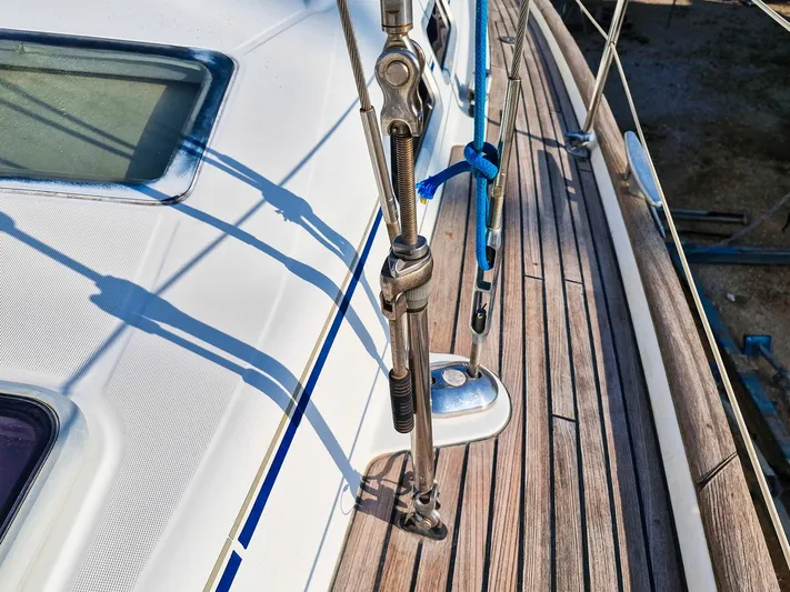  Yacht Photos Pics Deck of 2004 Beneteau Oceanis 423 sailboat with rigging and wooden finish.