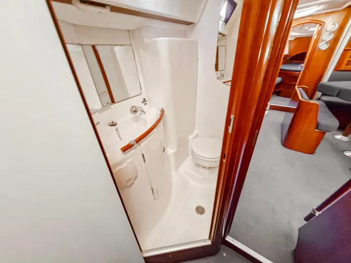  Yacht Photos Pics Compact bathroom in 2004 Beneteau Oceanis 423 yacht, featuring toilet and sink.