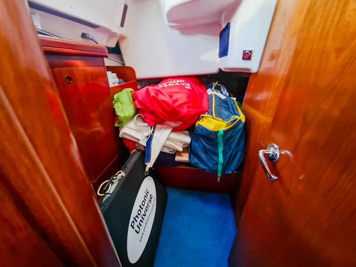  Yacht Photos Pics Interior cabin of 2004 Beneteau Oceanis 423 with storage and colorful bags.