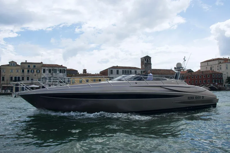  Yacht Photos Pics 2006 Riva Rivale 52 yacht cruising near historic waterfront buildings.