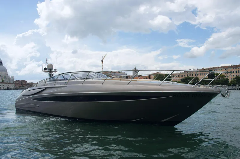  Yacht Photos Pics 2006 Riva Rivale 52 yacht on water under cloudy sky.