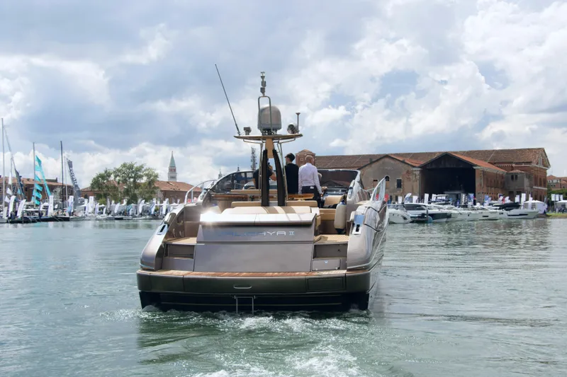 Yacht Photos Pics 2006 Riva Rivale 52 yacht cruising in a marina with cloudy skies.