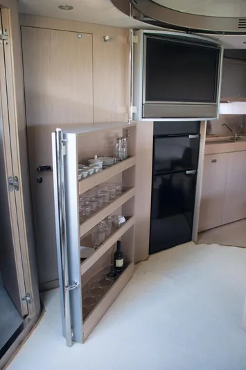  Yacht Photos Pics Luxurious interior of 2006 Riva Rivale 52 yacht with bar and TV.