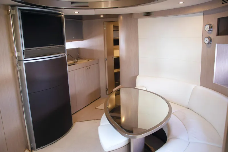  Yacht Photos Pics Luxurious interior of 2006 Riva Rivale 52 yacht with modern kitchen and seating area.