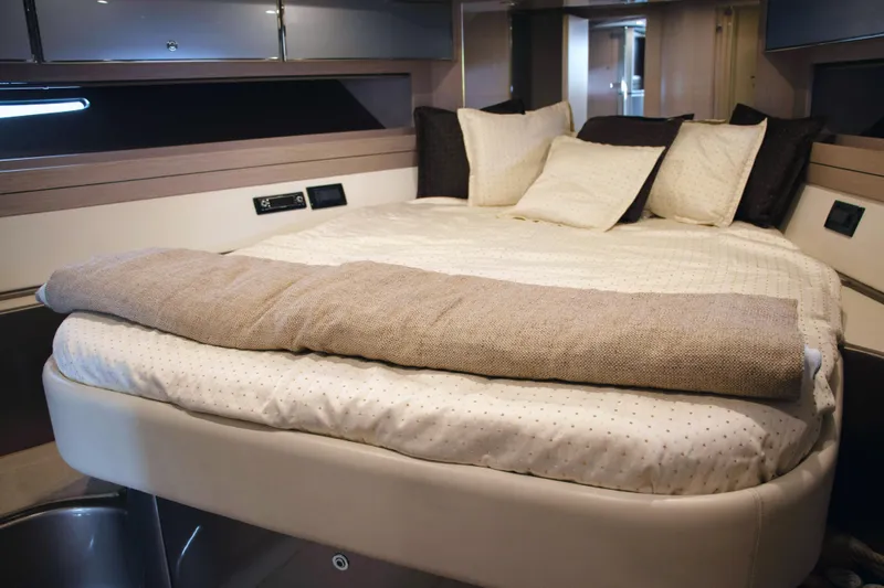  Yacht Photos Pics Luxurious cabin interior of a 2006 Riva Rivale 52 yacht with a cozy bed.