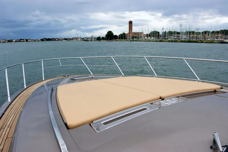  Yacht Photos Pics 2006 Riva Rivale 52 yacht deck with scenic waterfront view.