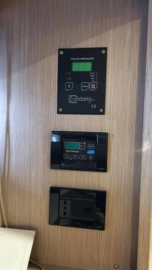  Yacht Photos Pics Control panel on a 2006 Riva Rivale 52 yacht, featuring digital displays and switches.