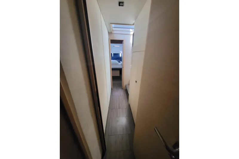  Yacht Photos Pics Narrow hallway inside 2018 Fountaine Pajot Saona 47 yacht, featuring modern interior design.