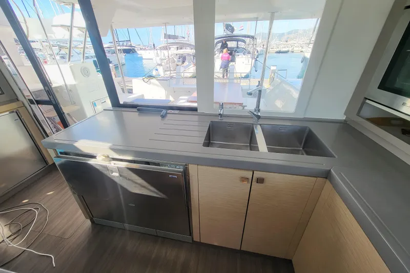  Yacht Photos Pics Interior of 2018 Fountaine Pajot Saona 47 yacht kitchen with double sink and marina view.