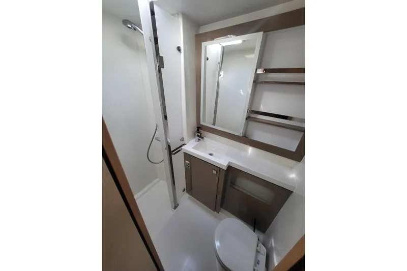  Yacht Photos Pics Modern bathroom in 2018 Fountaine Pajot Saona 47 yacht, featuring shower, sink, and toilet.