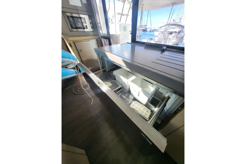  Yacht Photos Pics Open drawer in 2018 Fountaine Pajot Saona 47 yacht interior, showcasing storage space.