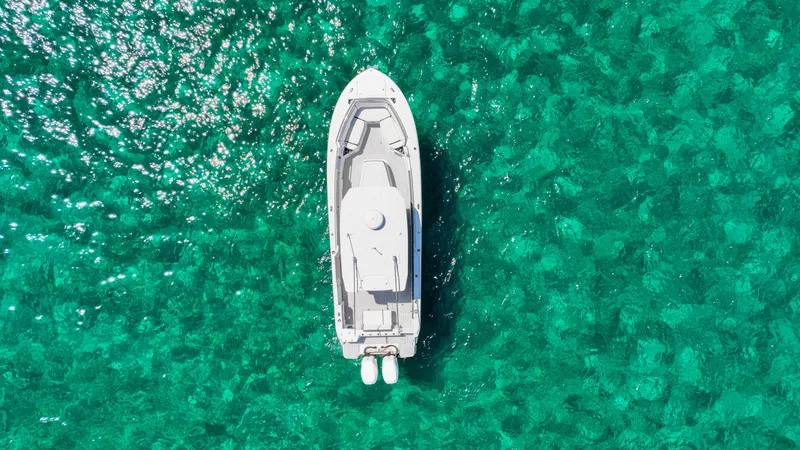  Yacht Photos Pics Aerial view of 2020 Blackfin 332 CC boat on clear turquoise water.