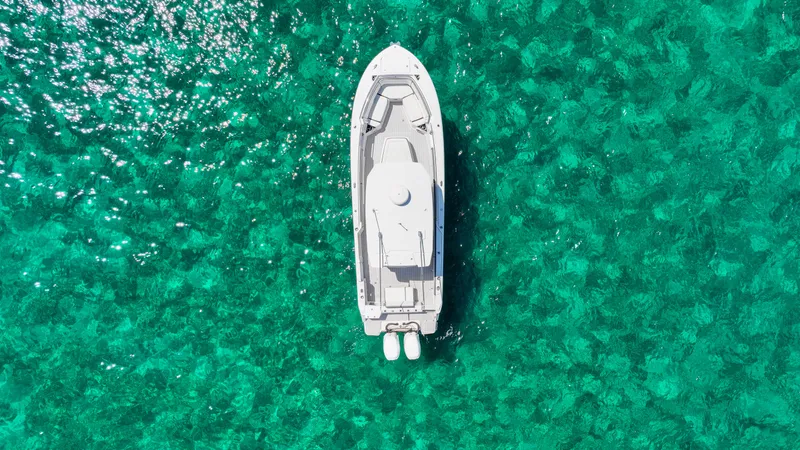  Yacht Photos Pics Aerial view of 2020 Blackfin 332 CC boat on clear turquoise water.