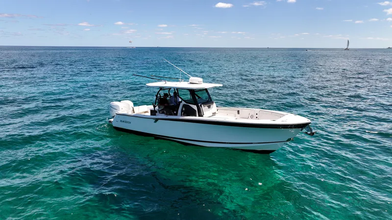  Yacht Photos Pics 2020 Blackfin 332 CC boat on clear blue ocean waters.