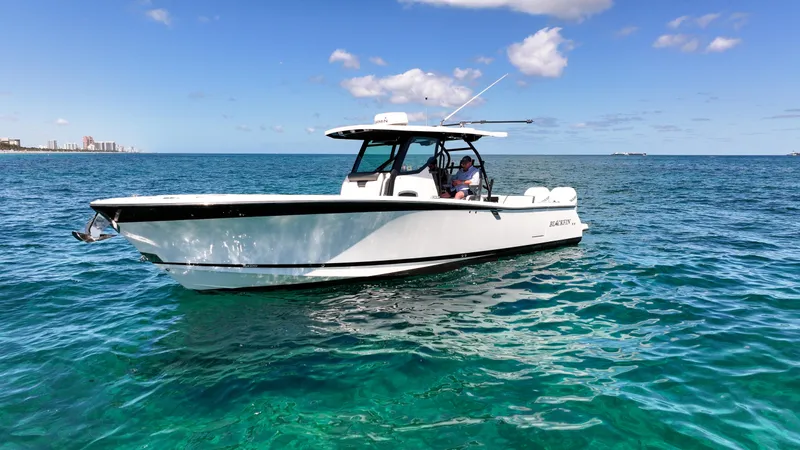  Yacht Photos Pics 2020 Blackfin 332 CC boat on clear blue ocean under sunny sky.