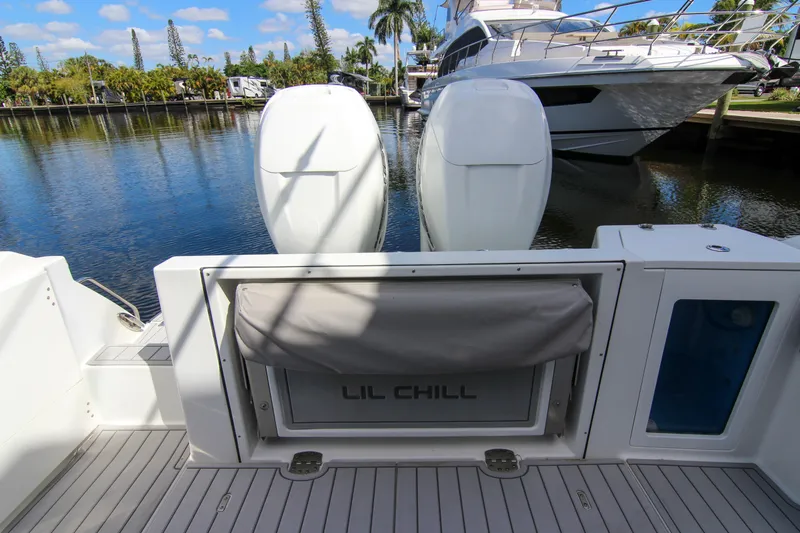  Yacht Photos Pics 2020 Blackfin 332 CC boat with dual engines docked near luxury yacht.