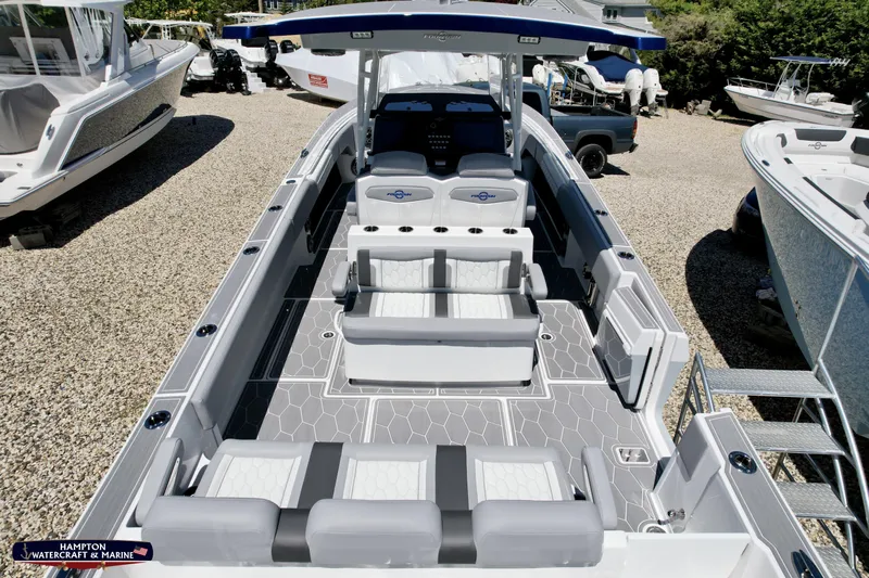 Mundinger Brokerage Yacht Photos Pics 2023 Fountain 34 SC boat with sleek seating and modern design in a marina setting.