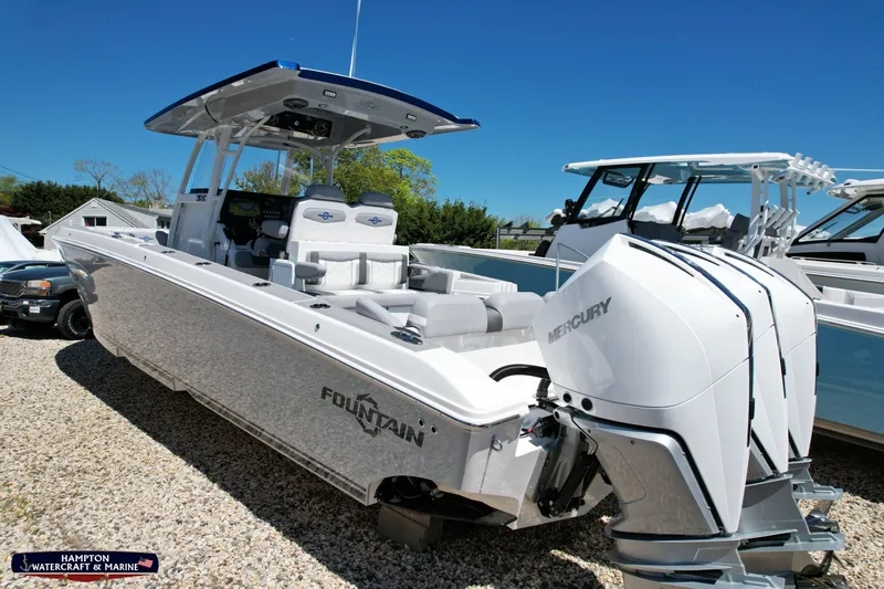 Mundinger Brokerage Yacht Photos Pics 2023 Fountain 34 SC boat with Mercury engines, displayed outdoors on gravel.