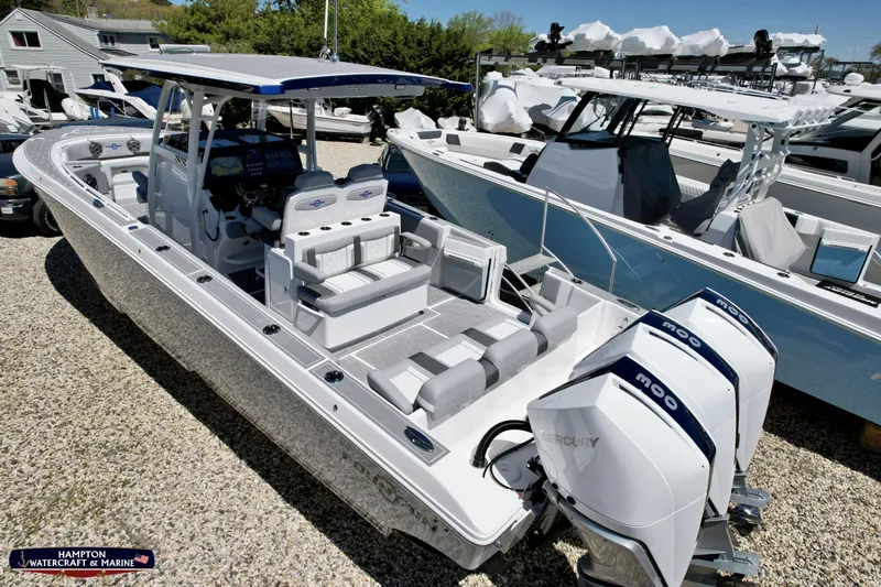 Mundinger Brokerage Yacht Photos Pics 2023 Fountain 34 SC boat with triple Mercury engines at a marina.