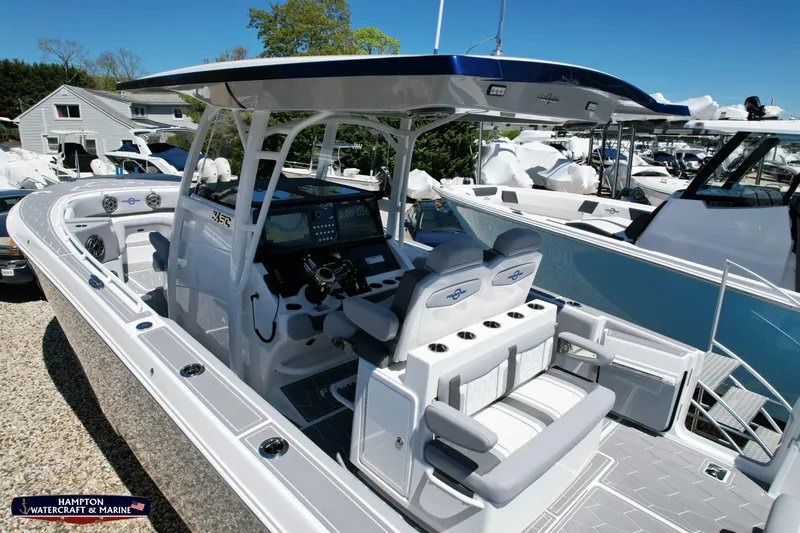 Mundinger Brokerage Yacht Photos Pics 2023 Fountain 34 SC boat with modern cockpit and seating at a marina.
