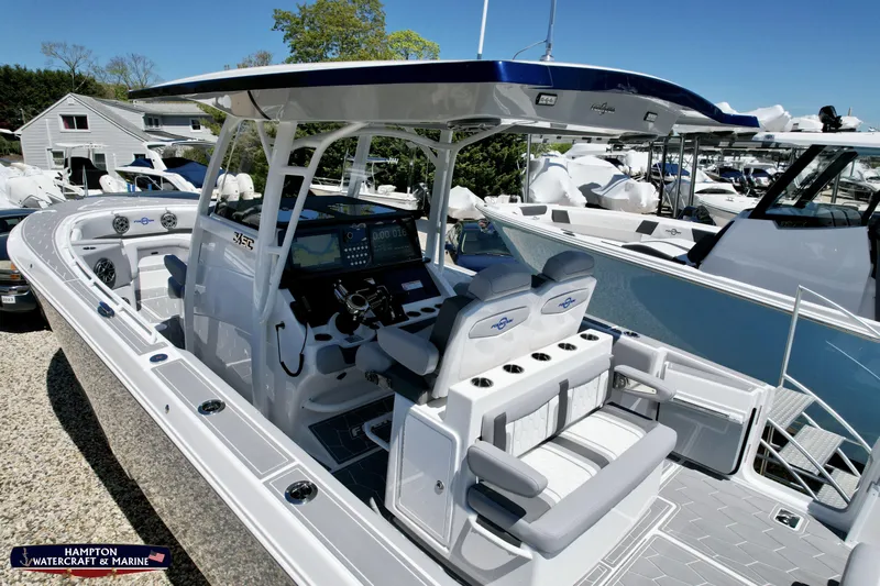 Mundinger Brokerage Yacht Photos Pics 2023 Fountain 34 SC boat with modern cockpit and seating at a marina.