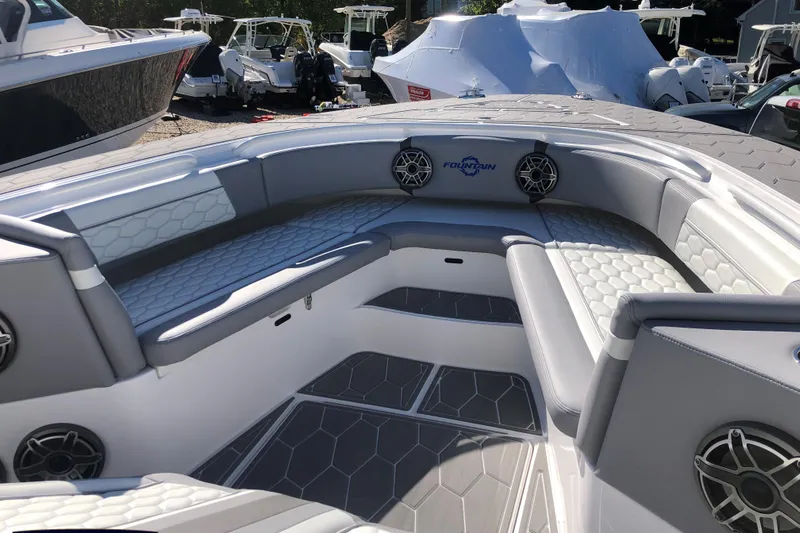 Mundinger Brokerage Yacht Photos Pics 2023 Fountain 34 SC boat interior with gray seating and speakers.