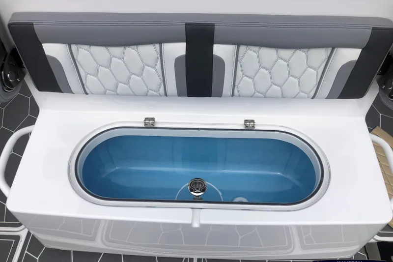 Mundinger Brokerage Yacht Photos Pics 2023 Fountain 34 SC boat interior with open storage compartment and cushioned seating.