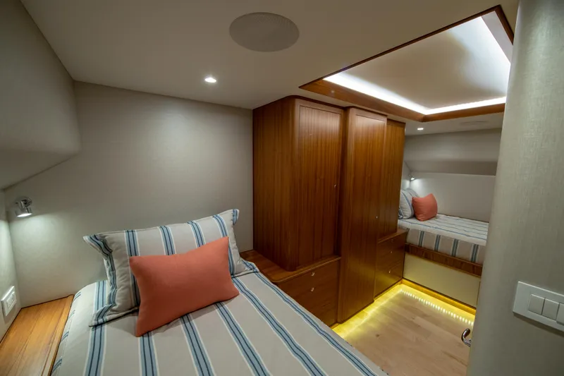 Privateer Yacht Photos Pics Luxurious cabin interior of 2019 Jarrett Bay 67 Custom yacht with striped bedding.