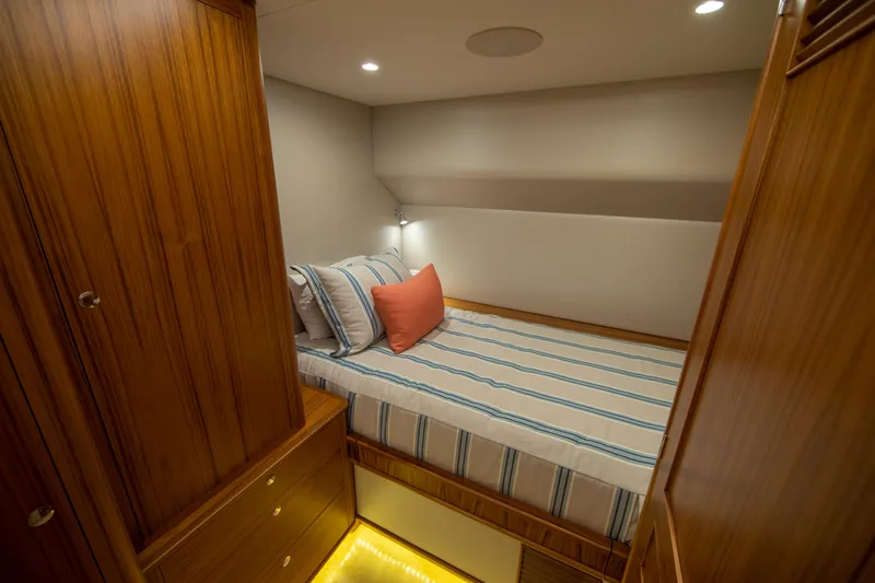 Privateer Yacht Photos Pics Cozy cabin interior of 2019 Jarrett Bay 67 Custom yacht with striped bedding.