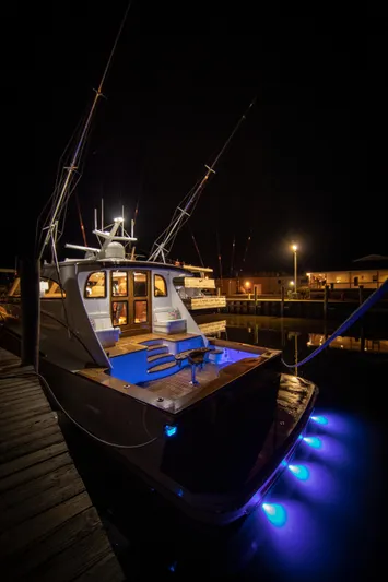 Privateer Yacht Photos Pics 2019 Jarrett Bay 67 Custom yacht docked at night with blue underwater lights.