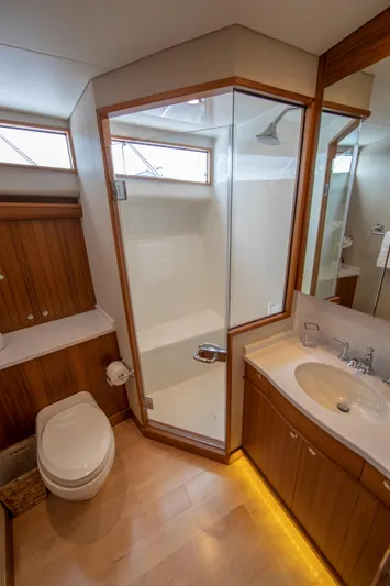 Privateer Yacht Photos Pics Luxurious bathroom in 2019 Jarrett Bay 67 Custom yacht with shower, sink, and toilet.
