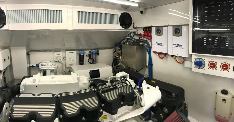 Privateer Yacht Photos Pics Engine room of 2019 Jarrett Bay 67 Custom yacht with CAT C18 engine and Dolphin battery chargers.