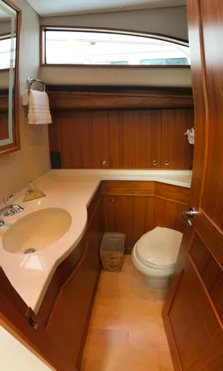 Privateer Yacht Photos Pics 2019 Jarrett Bay 67 Custom yacht bathroom with wooden cabinetry and modern fixtures.