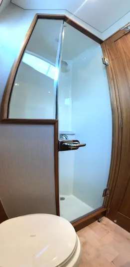 Privateer Yacht Photos Pics 2019 Jarrett Bay 67 Custom yacht bathroom with glass shower and wooden accents.