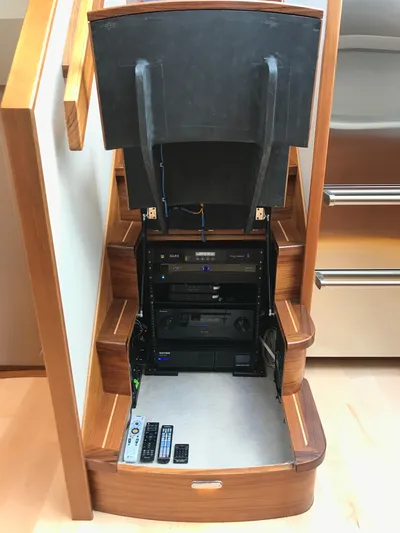 Privateer Yacht Photos Pics Hidden electronic equipment compartment under stairs in a 2019 Jarrett Bay 67 Custom yacht.