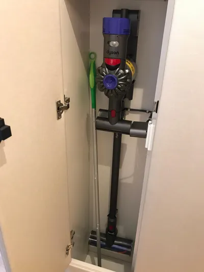 Privateer Yacht Photos Pics Dyson vacuum cleaner stored in a cabinet on a 2019 Jarrett Bay 67 Custom yacht.
