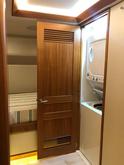 Privateer Yacht Photos Pics Interior of 2019 Jarrett Bay 67 Custom yacht with wooden door and laundry area.