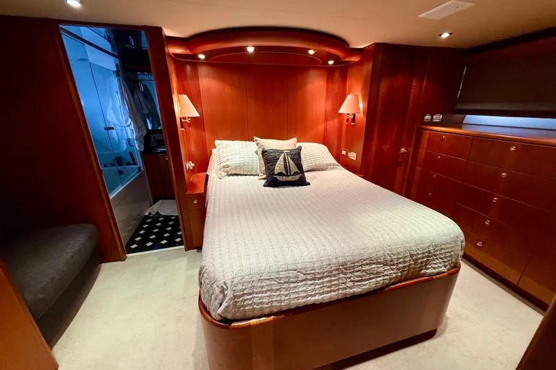 Southern Lady Yacht Photos Pics Luxurious bedroom in 2002 Cheoy Lee 72 Raised Pilot House Motor Yacht, featuring elegant wood finishes.