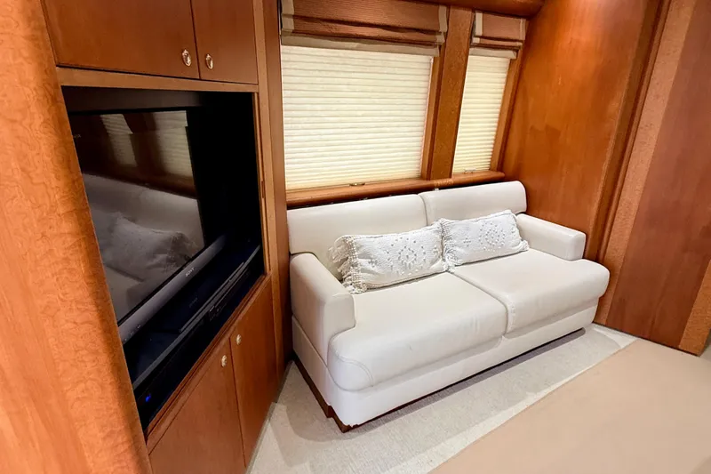 Southern Lady Yacht Photos Pics Luxurious interior of 2002 Cheoy Lee 72 Yacht with white sofa and wood paneling.